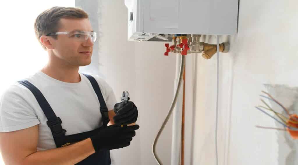 Professional boiler service: qualified technician checking a natural gas boiler at home