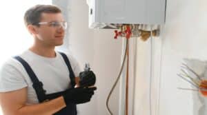Professional boiler service: qualified technician checking a natural gas boiler at home